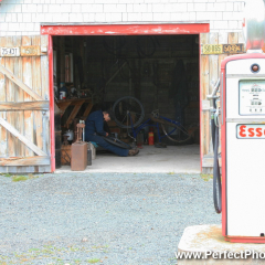 Esso Garage, fixing bicycle tire, Memory Lane Heritage Village, Museum in Lake Charlotte, Nova Scotia, Canada