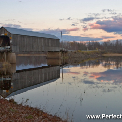 Scenic reflections of Starkey Covered Bridge at dusk, Long Creek number one, outside Sussex, New Brunswick, Canada, North America