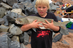 Boy holding 36 inch Sea Bass fish, he caught,  Noel, East Hants, Nova Scotia, Canada