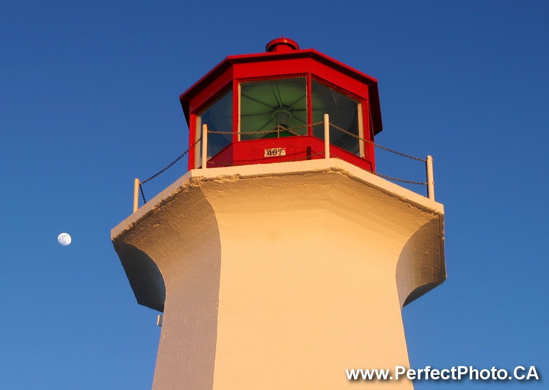 Moon at head of Peggy's Cove Lighthouse, near Halifax, Nova Scotia, Canada, North America, Atlantic Ocean, red, white, sea, coast, coastal, protection, safety
