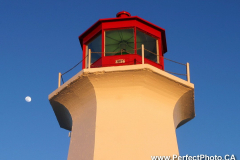 Moon at head of Peggy's Cove Lighthouse, near Halifax, Nova Scotia, Canada, North America, Atlantic Ocean, red, white, sea, coast, coastal, protection, safety